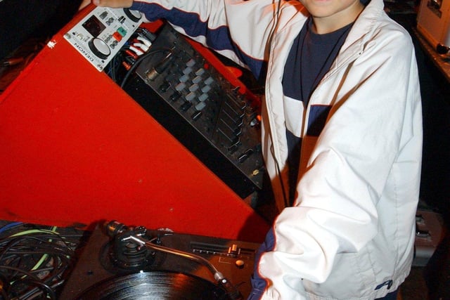 Eleven year old DJ, Tom Midgley at the decks in Maximes Nightclub.
