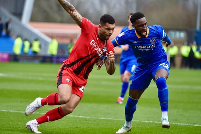 Former Latics defender Chey Dunkley (right) was the victim of a punch during Saturday's game, according to Shrewsbury boss Paul Hurst