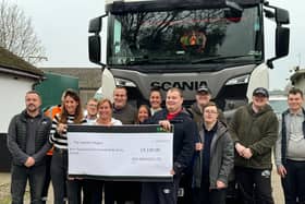 Staff from SED Services Ltd hand over a cheque to trainees at The Hamlet
