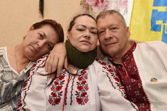 Ukrainian Svitlana Vorozhkina, centre, who is disabled and has lived in Wigan for over 12 years, is delighted to welcome refugee parents, Ganna, left, and Sergii, right, who fled the war in Ukraine, but are unhappy at the lack of support they have.  They also want help to send emergency and medical items to people who are still in Ukraine.