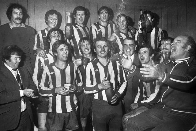 Wigan Athletic trainer Kenny Banks leads the champagne celebrations with the players, manager Ian McNeill and chairman Arthur Horrocks after the match against Division 3 Sheffield Wednesday in the FA Cup 2nd round match at Springfield Park on Saturday 17th of December 1977 which Latics won 1-0 with a goal from Maurice Whittle.