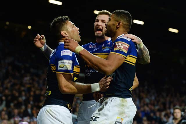 Leeds Rhinos' Joel Moon (left) celebrates with Zac Hardaker and Kallum Watkins (right) after scoring his side's second try during the First Utility Super League Grand Final at Old Trafford, Manchester