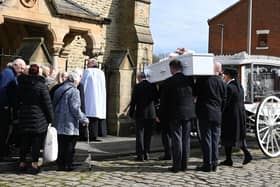 Pam Culshaw's coffin is borne into Christ Church, Ince, as mourners look on