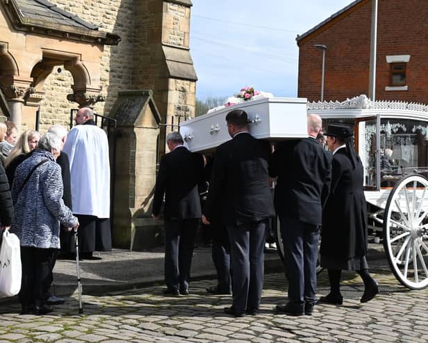 Pam Culshaw's coffin is borne into Christ Church, Ince, as mourners look on