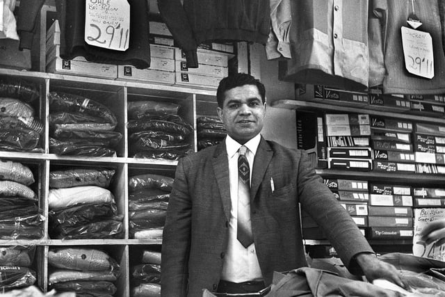 Menswear stall holder Ali Khan in the Old Arcade, Wigan, in the early 1970s.