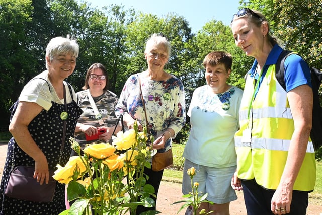 The group admire the rose garden in Mesnes Park, Wigan.