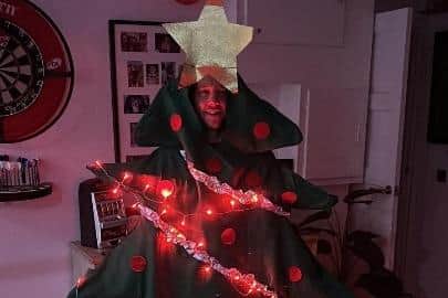 Tony Taylor pictured in a Christmas tree fancy dress outfit that he will wear for the charity walk.