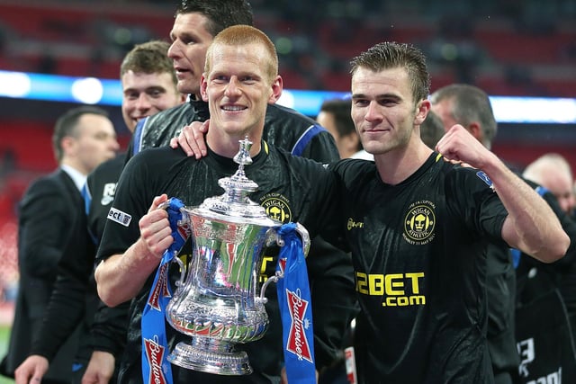 Wigan Athletic winning goal scorer Ben Watson celebrates with team-mate Callum McManaman (right) and the FA Cup trophy after the FA Cup Final at Wembley Stadium, London. PRESS ASSOCIATION Photo.