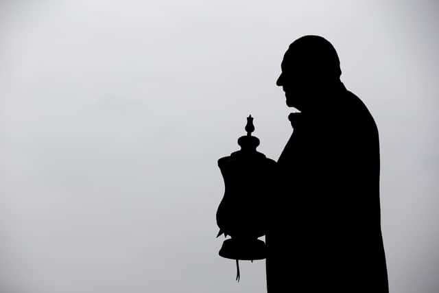 The statue of Dave Whelan with the FA Cup