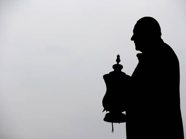 The statue of Dave Whelan with the FA Cup