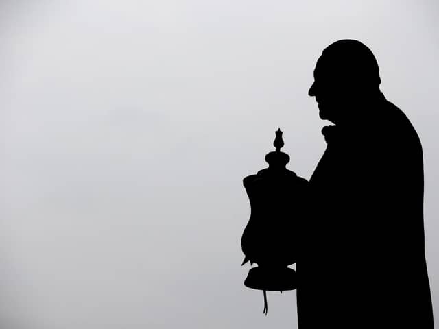 The statue of Dave Whelan with the FA Cup