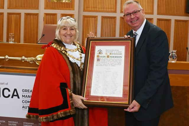 The outgoing Mayor of Wigan, Coun Marie Morgan, makes a presentation to her successor Coun Kevin Anderson