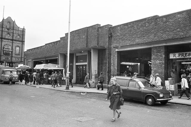 The Hope Street side of Wigan Market Hall with Crank and Burton Baths Showrooms on the left leading into Woodcock Street in 1980.