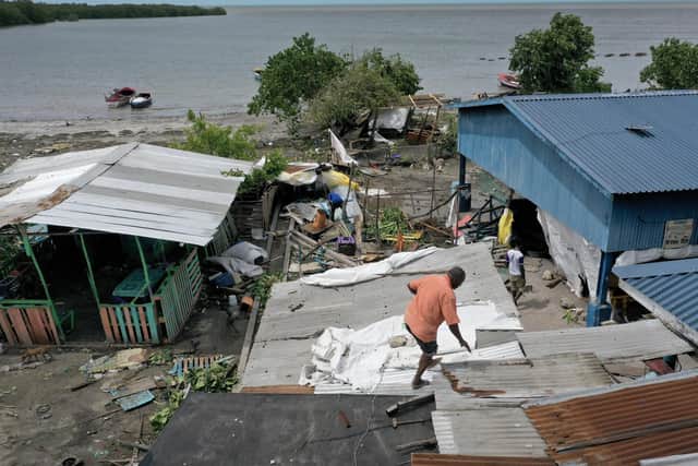 OLD HARBOR, JAMAICA - JULY 04: Jungle Simons fixes the roof on a building after Hurricane Beryl passed through the area on July 04, 2024, in Old Harbor, Jamaica. Hurricane Beryl, now a Category 3 storm, continues toward Mexico after passing through Caribbean islands, including Jamaica. (Photo by Joe Raedle/Getty Images)