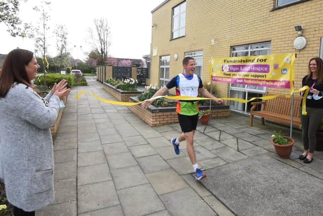 Martin Foster gets a warm welcome as he runs to Wigan and Leigh Hospice
