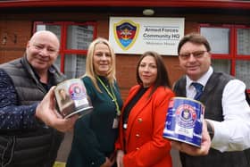 Antony Winnard, left, and John Winnard, right, owners of William Santus and Co the makers of Uncle Joe's Mint Balls, with the Tommy Tins, created to celebrate the 75th Anniversary of VE Day, with a percentage of each sale donated to charity.  Here they present £400 to The Armed Forces Community Hub, Wigan, represented by Armed Forces key worker Gillian Burchall and Hub managing director Laura Ingham, second from right.