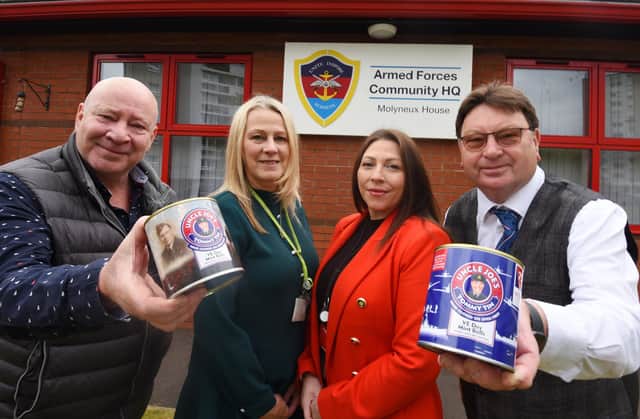 Antony Winnard, left, and John Winnard, right, owners of William Santus and Co the makers of Uncle Joe's Mint Balls, with the Tommy Tins, created to celebrate the 75th Anniversary of VE Day, with a percentage of each sale donated to charity. Here they present £400 to The Armed Forces Community Hub, Wigan, represented by Armed Forces key worker Gillian Burchall and Hub managing director Laura Ingham, second from right.