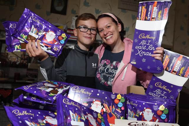 Charlie Heslin, 11, with mum Tracey and Christmas gifts