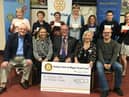 Wigan Rotary Club members present cheques to previous recipients