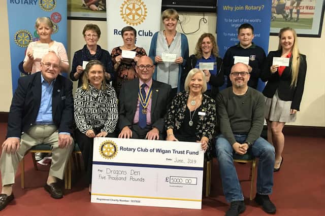 Wigan Rotary Club members present cheques to previous recipients