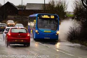 A bus goes through the floodwater on Bolton Road, Stubshaw Cross on Tuesday. Picture by Julian Sorfleet