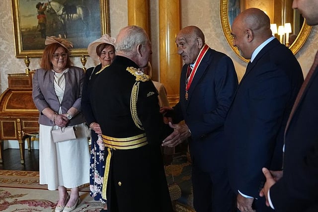 Sir Billy Boston with King Charles III during his investiture ceremony