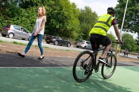 Cyclists and walkers using the Robin Park Road cycle and walking lanes