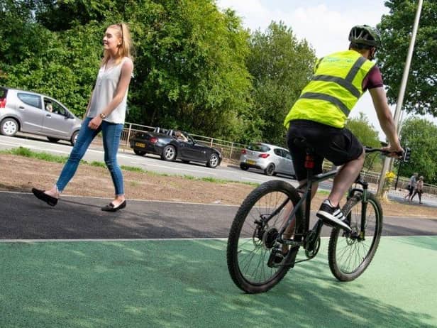 Cyclists and walkers using the Robin Park Road cycle and walking lanes