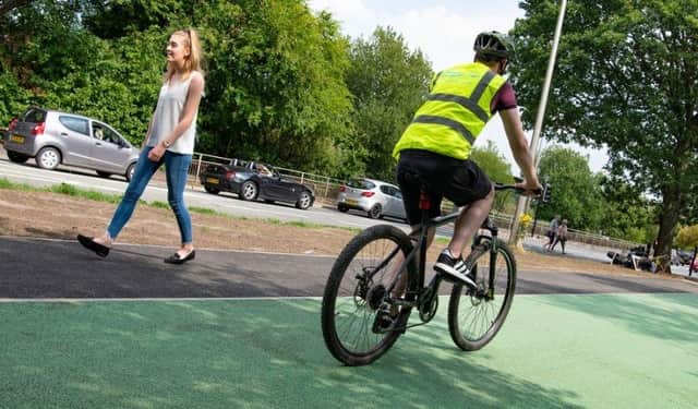 Cyclists and walkers using the Robin Park Road cycle and walking lanes