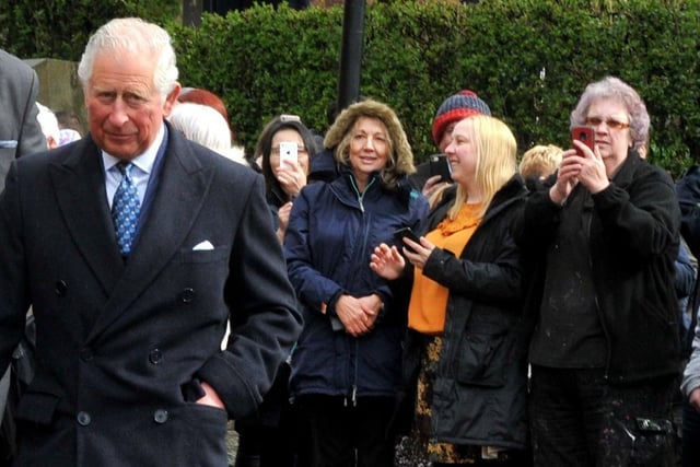 Prince Charles meets the crowds of people outside The Old Courts, Wigan.