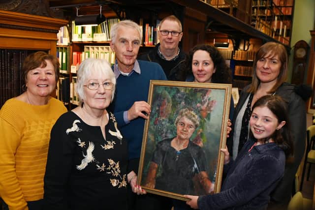 Relatives of Mary Tomlinson, a Pit Brow lass who educated herself and became a doctor in India, meet for the first time. From left, Sharon Tomlinson, Mary Griffiths James, Alan Tomlinson, Rod Knight, Joanne Tomlinson, Lesley Knight and Faith Whitear, ten, holding a painting of Mary Tomlinson.