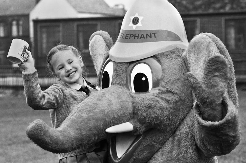 Fire Service mascot Welephant with Jennifer Raw a pupil at St. Peter's Primary School, Bryn, who won a fire safety slogan competition run by GMC Fire Service in February 1989.