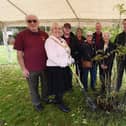 The former Mayor of Wigan Coun Marie Morgan and Melanie Bryan DL, right, joined by members of The Bridgers - Howe Bridge community group,  at the tree-planting ceremony, with a rowan tree, one which formed the tree-of trees outside Buckingham Palace