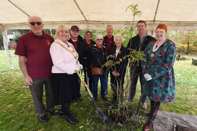 The former Mayor of Wigan Coun Marie Morgan and Melanie Bryan DL, right, joined by members of The Bridgers - Howe Bridge community group,  at the tree-planting ceremony, with a rowan tree, one which formed the tree-of trees outside Buckingham Palace