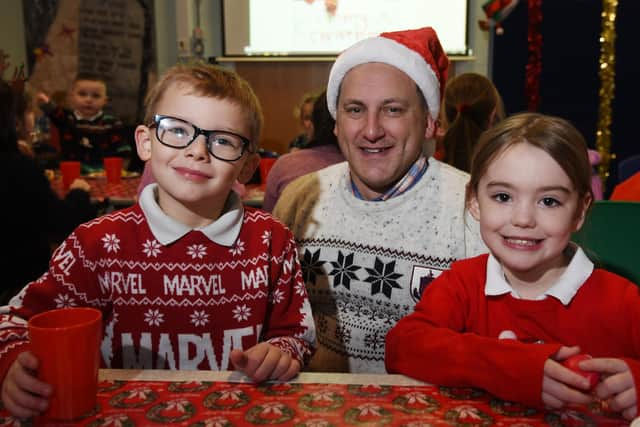 WIGAN - 14-12-22   Staff and pupils celebrate gaining a good OFSTED report, with a Christmas party and Christmas dinner.  Headteacher Guy Lovgreen with pupils enjoying a Christmas dinner.