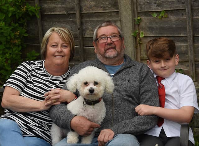 Retired postman Mick Marsh with wife Doreen, grandson Archie, eight, and dog Fergie