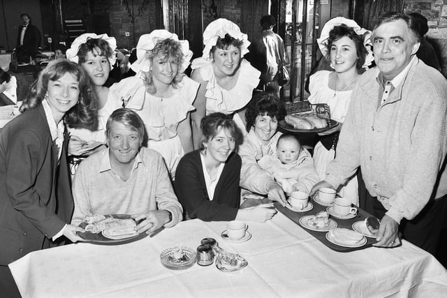 Coronation Street stars Helen Worth who played Gail Tilsley and Bill Tarmey, Jack Duckworth, help serving wenches to cater to Standish Lower Ground family the Hassalls at a "Have a Heart" charity day in aid of the British Heart Foundation at Park Hall on Sunday 9th of April 1989.