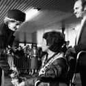 Princess Diana accepts a posy of flowers from Stephen Hooton of Orrell watched by proud dad Jim at Wigan North Western station as she and Prince Charles made their way to open a factory in Skelmersdale on Wednesday 23rd of April 1986.