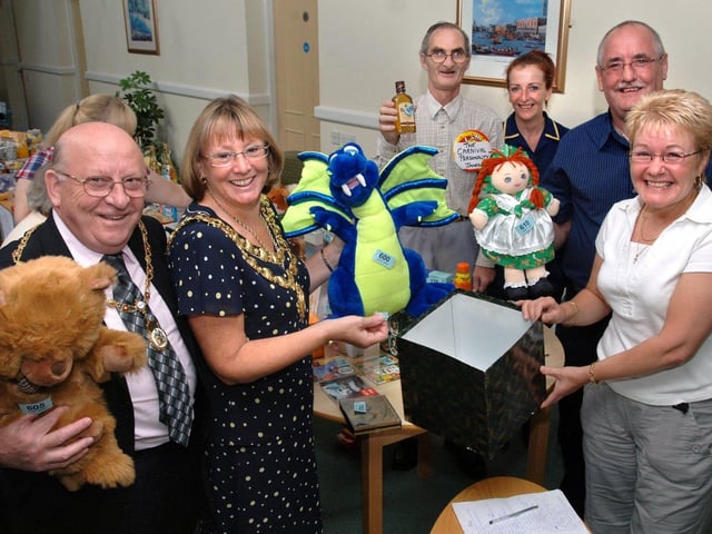 Mayor of Wigan, Coun. Eunice Smethurst, and Consort, Harry, have a go on the tombola stall run by resident, James Ashurst, and staff Diane Disley, Stephen Roche and Theresa Reeves at Eliot Gardens extra care mental health scheme home at Worsley Mesnes where a fund raising carnival fayre was being held.
