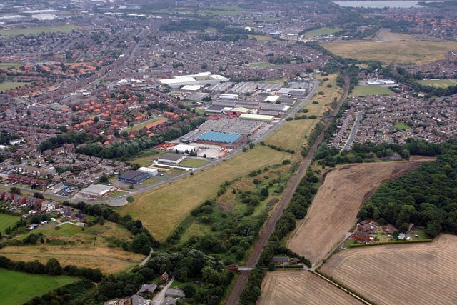 Part of the route of the proposed A5225 road between Pemberton, and Lamberhead Green Industrial Estate, left, and the Wigan Wallgate to Liverpool railway line and Highfield, right, going off up past Scotman's Flash at the top right.