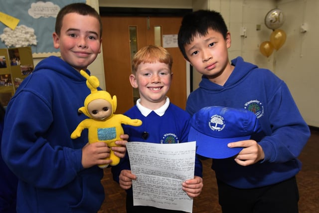 Members of the school council with some of the items from the time capsule, with a cassette tape of The Spice Girls, Tamagotchi (handheld digital pet popular in 1997), school work, letters and newspapers from the day.