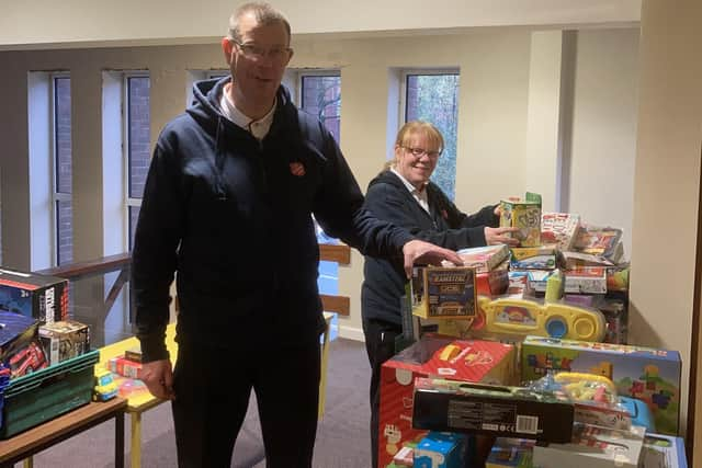 Majors, Mark and Alison Lewis, receive gifts for The Salvation Army Wigan's Christmas Present Appeal.