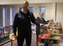 Majors, Mark and Alison Lewis, receive gifts for The Salvation Army Wigan's Christmas Present Appeal.