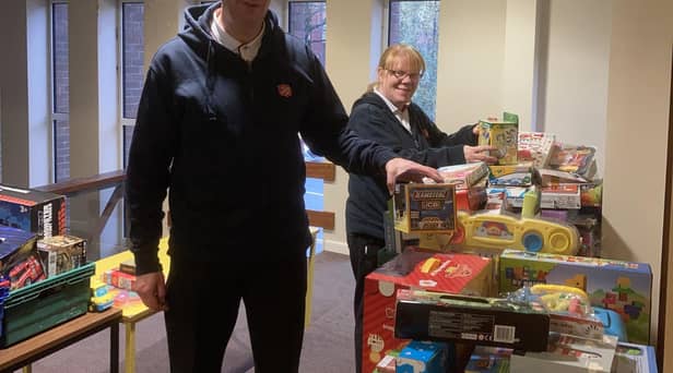 Majors, Mark and Alison Lewis, receive gifts for The Salvation Army Wigan's Christmas Present Appeal.
