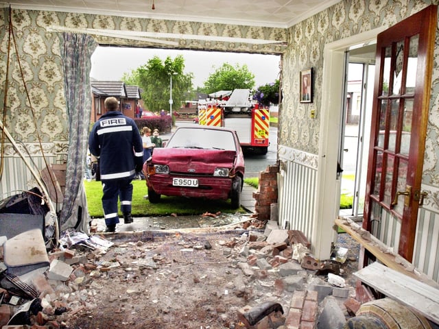 The devastation caused by a car crashing into Gordon Griffin's house in Morris Street, Scholes, on Friday 19th of July 2002. The Ford Fiesta smashed through the front of his house pinning him to the wall of his lounge and landed on top of him but he luckily escaped serious injury. The driver also wasn't badly injured but was arrested.