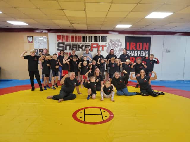 Councillors Ron Conway, Laura Flynn and Chris Ready with members of Aspull Olympic Wrestling Club
