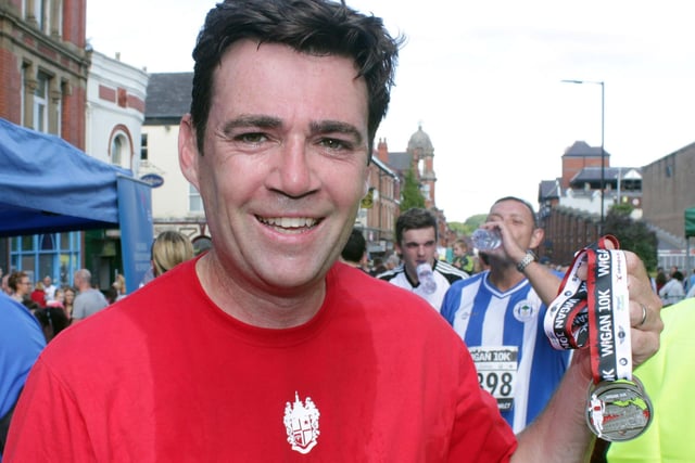 Andy Burnham with his medal as he finishes the first Wigan 10K event in 2013.