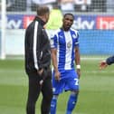 Latics skipper Tendayi Darikwa has words with Bolton boss Ian Evatt just before the second half