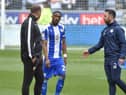 Latics skipper Tendayi Darikwa has words with Bolton boss Ian Evatt just before the second half