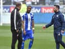 Latics skipper Tendayi Darikwa has words with Bolton boss Ian Evatt just before the second half